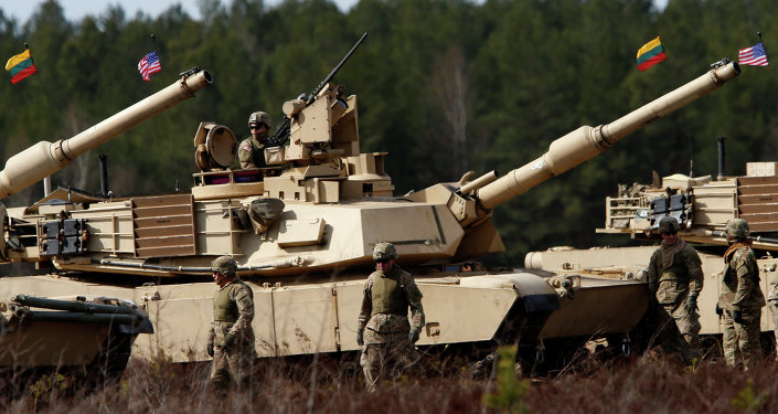 US soldiers from the 2nd Battalion, 1st Brigade Combat Team, 3rd Infantry Division at the M1A2 Abrams battle tank during a military exercise at the Gaiziunu Training Range in Pabrade some 60km.(38 miles) north of the capital Vilnius, Lithuania, Thursday, April 9, 2015