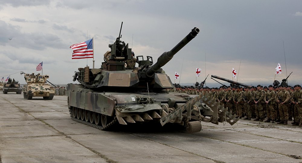 U.S servicemen drive their armored vehicles at the opening ceremony of U.S, British and Georgian troops joint military exercises at the Vaziani military base outside Tbilisi, Georgia, Wednesday, May 11, 2016.