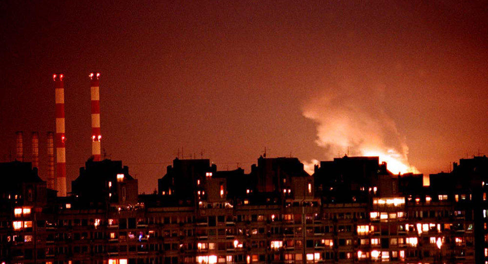 Chamas dos incêndios em resultado dos ataques aéreos da OTAN iluminam o céu de Belgrado, Iugoslávia, 24 de março de 1999