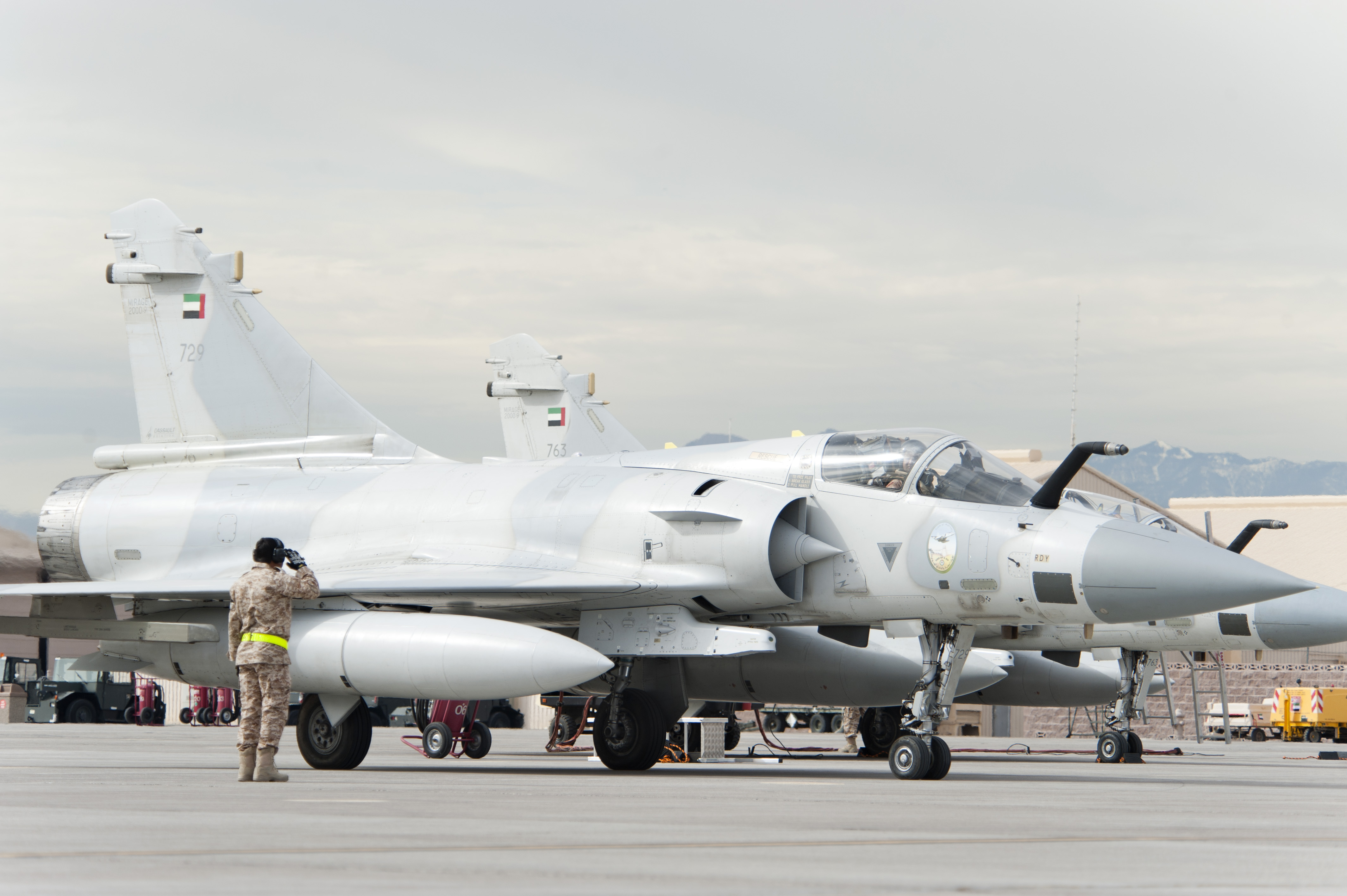 A United Arab Emirates Air Force crew chief salutes a Mirage 2000-9 pilot prior to take-off on the Nellis Air Force Base flight line Jan. 23, 2013. Six UAEAF's Mirage 2000-9 are participating in Red Flag 13-2 exercise. (U.S. Air Force photo by Lawrence Crespo)