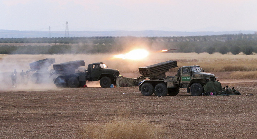 In this photo taken on Wednesday, Oct. 7, 2015, Syrian army rocket launchers fire near the village of Morek in Syria