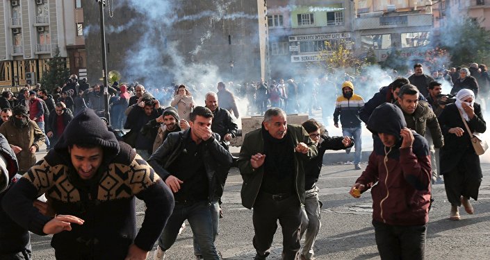 Riot police fire tear gas to disperse demonstrators during a protest against the curfew in Sur district, in the southeastern city of Diyarbakir, Turkey, December 14, 2015