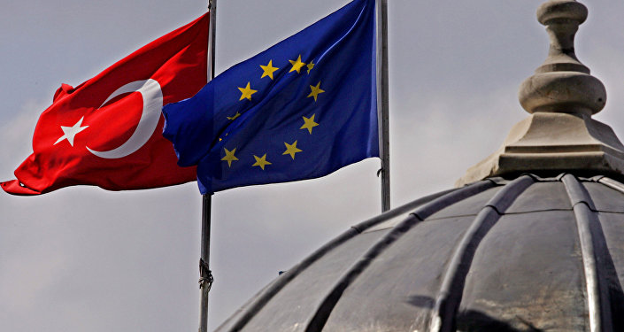 Flags of Turkey, left, and the European Union fly over the dome of a mosque in Istanbul, Turkey