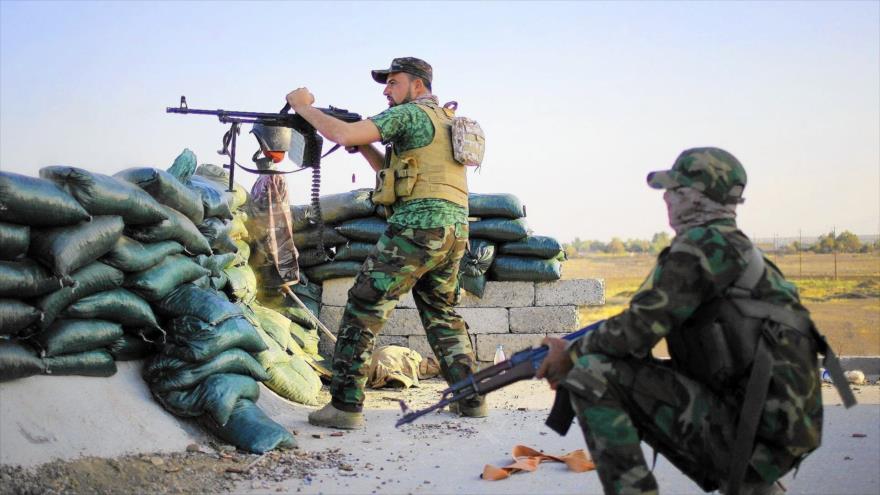 As forças iraquianas Populares tomar posição contra os terroristas.