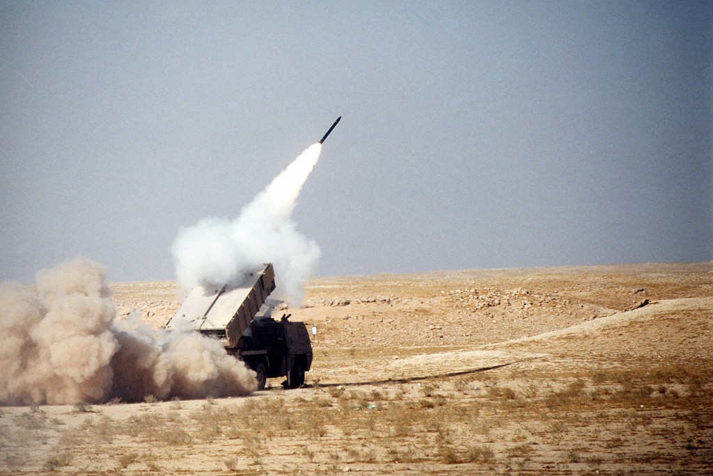 An Avibras ASTROS-II SS-30 rocket is launched from an ASTROS SS-30 multiple rocket system mounted on the back of a Tectran 6x6 AV-LMU truck.  The display is part of a demonstration of Saudi Arabian equipment taking place during Operation Desert Shield.