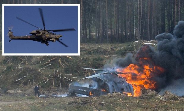 ALTERNATIVE CROP OF XAZ102 - A Russian military helicopter burns after crashing during an aerobatic display in Dubrovichi, Russia, Sunday, Aug. 2, 2015 , killing one of its crew members and injuring another. The Mi-28 helicopter gunship was part of a flight of helicopters performing aerobatics at the Dubrovichi firing range in Ryazan region, about 170 kilometers (105 miles) southeast of Moscow, when it crashed Sunday. (Anton Nasonov, RZN.info/Photo via AP)