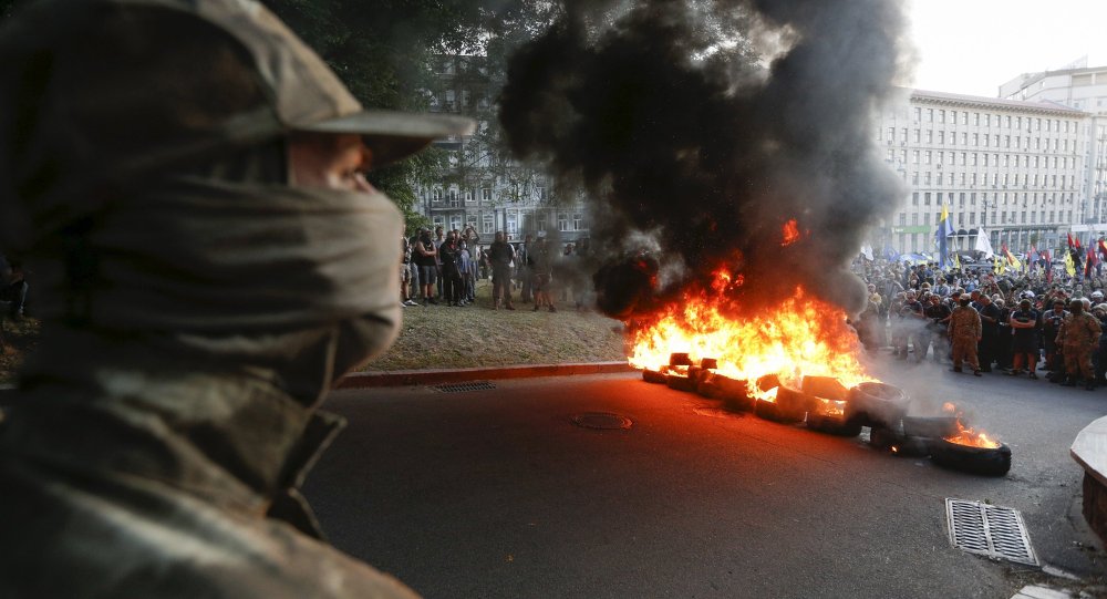 Tyres are set on fire during a rally held by members of the far-right radical group Right Sector, representatives of the Ukrainian volunteer corps and their supporters in central Kiev, Ukraine, July 3, 2015